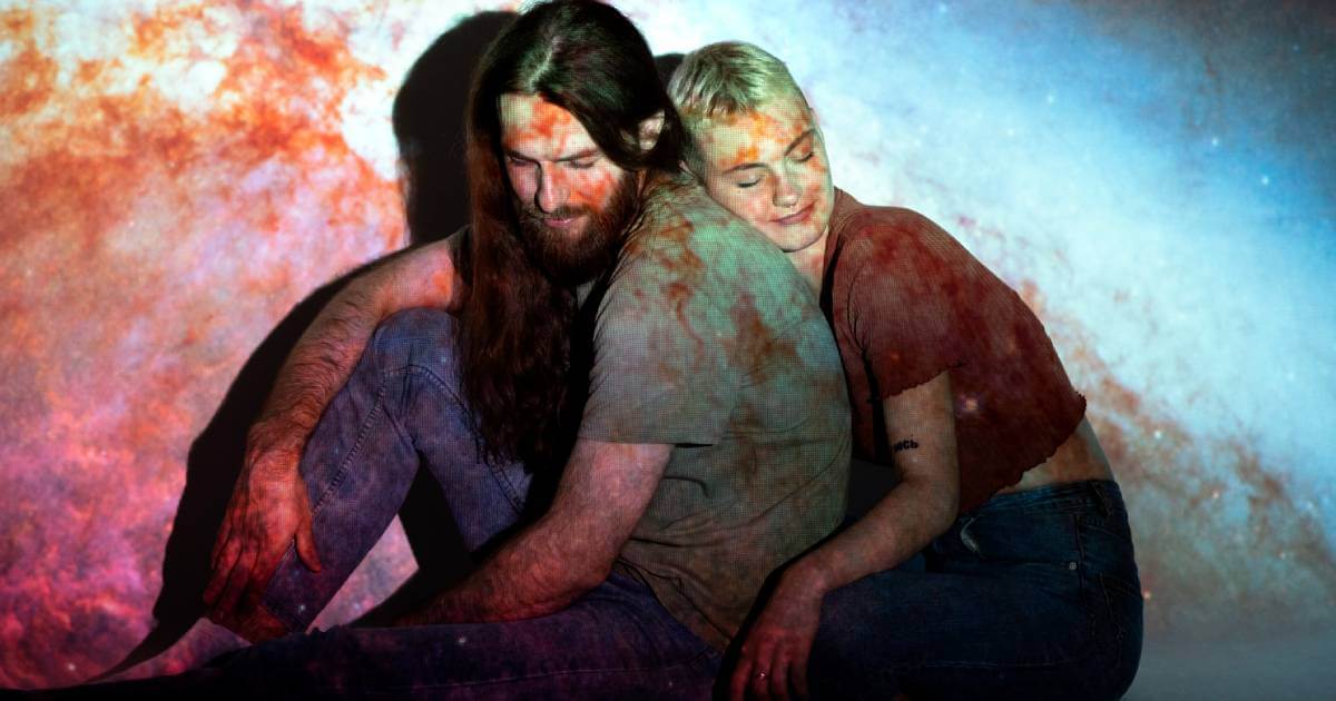 A thoughtful person gazing at a cosmic night sky, representing an atheist's perspective on love and destiny without divine intervention.