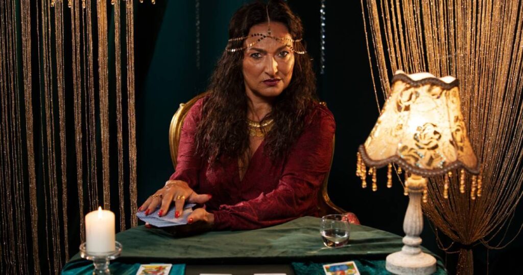 An astrologer interprets a complex natal chart, showing planetary positions and zodiac signs used for predicting future events.