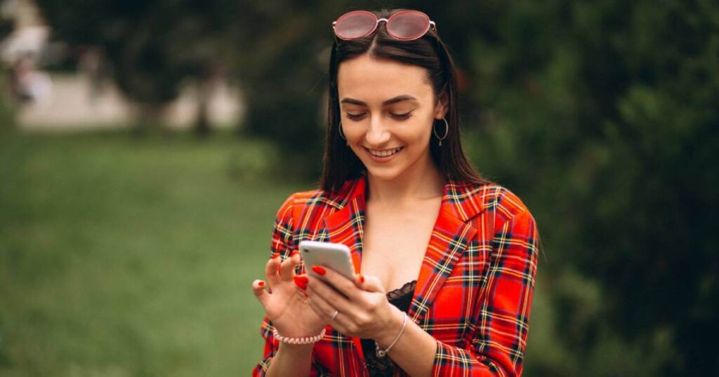 Someone selecting an auspicious mobile number on a smartphone screen showing numerology-compatible digits