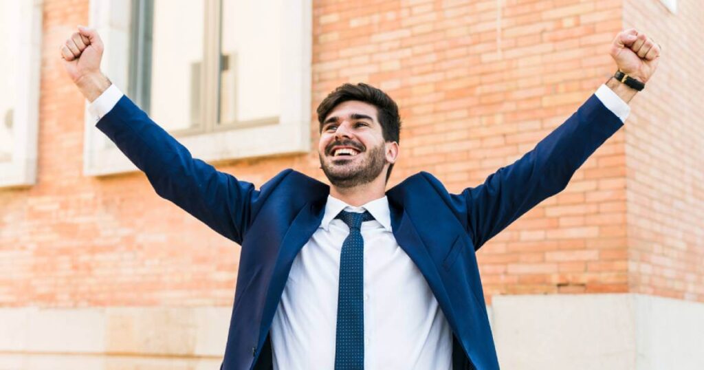A joyful person celebrating a law of attraction success story, feeling the empowerment of having manifested their dream life into reality.